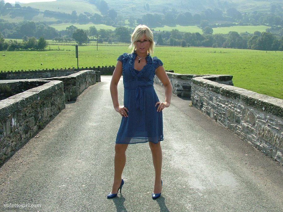 Sexy women in blue heels nude pantyhose and a cheeky blue dress outdoor